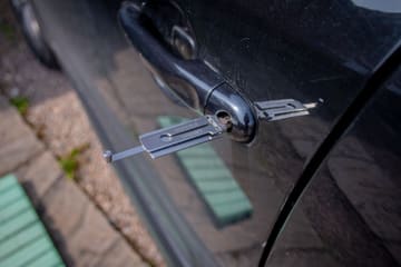 Lock-pick tool inserted into a car door lock cylinder