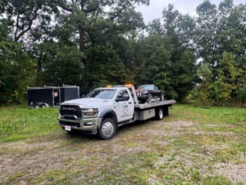 Safeway Services tow truck parked on grass with its bed loaded